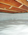 a moisture barrier installed on the walls and floors of a crawl space in Denton