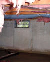 Texas crawl space with vents, showing mold, rot, and fiberglass insulation dripping off the ceiling.