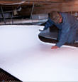 Mesquite insulation being installed in a crawl space.