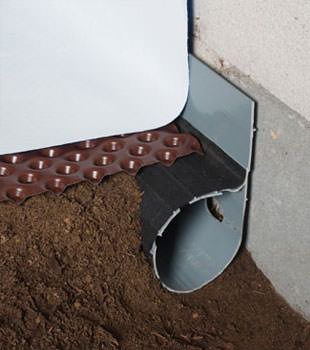 Closeup of a crawl space drainage system installed in Hurst