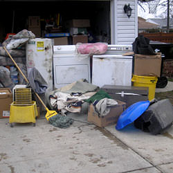 Soaked, wet personal items sitting in a driveway, including a washer and dryer in Mesquite.