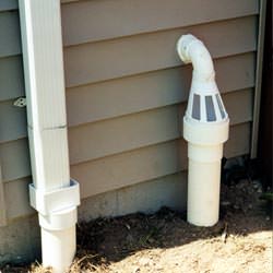 A grated sump pump discharge line fitting in Rowlett