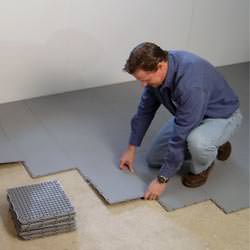 basement subfloor tiles being installed by a contractor in Burleson