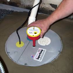 A newly installed sump pump system in a basement in Bedford