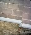 Our baseboard drain system installed on a corner in a Carrollton basement.