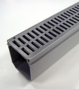 A closeup of our grated basement drainage pipe system, installed in Euless
