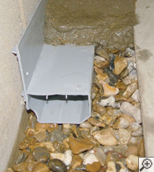 A no-clog basement french drain system installed in Grand Prairie