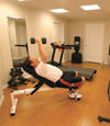 a basement gym and workout room with a wood laminate flooring, installed in Garland, TX