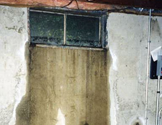 Water pouring out from a basement window in Garland