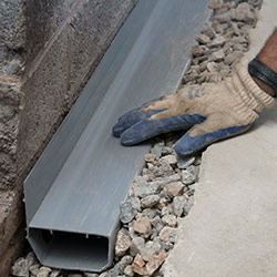 installing a drain tile system in a Bedford home